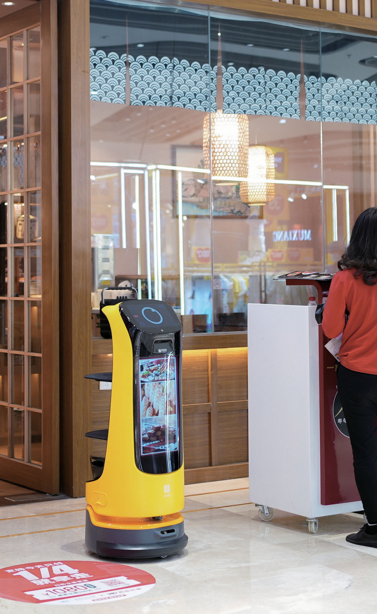 KettyBot is advertising in front of a store